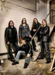 Excalion-bändin promokuva vuodelta 2006. Kuvassa viisi miestä, joista neljä seisoo maassa istuvan takana. Kuva on otettu nuhjuisessa kellarissa.
