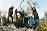 Soulgrind-bändin jäsenet seisovat korvessa sinisen taivaan alla. Kuvassa viisi miestä ja yksi nainen, joka nojaa puuhun oikeassa laidassa. Etualalla mies, jolla musta nahkatakki + pitkät mustat hiukset.