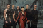 Within Temptation -bändi promokuvassa. Keskellä miehiä on bändin laulajatar, joka on pukeutunut punaiseen mekkoon.