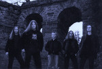 Burden Of Grief -bändin promokuva. Miehet seisovat kivikaaren edessä. Kuvassa viisi miestä.